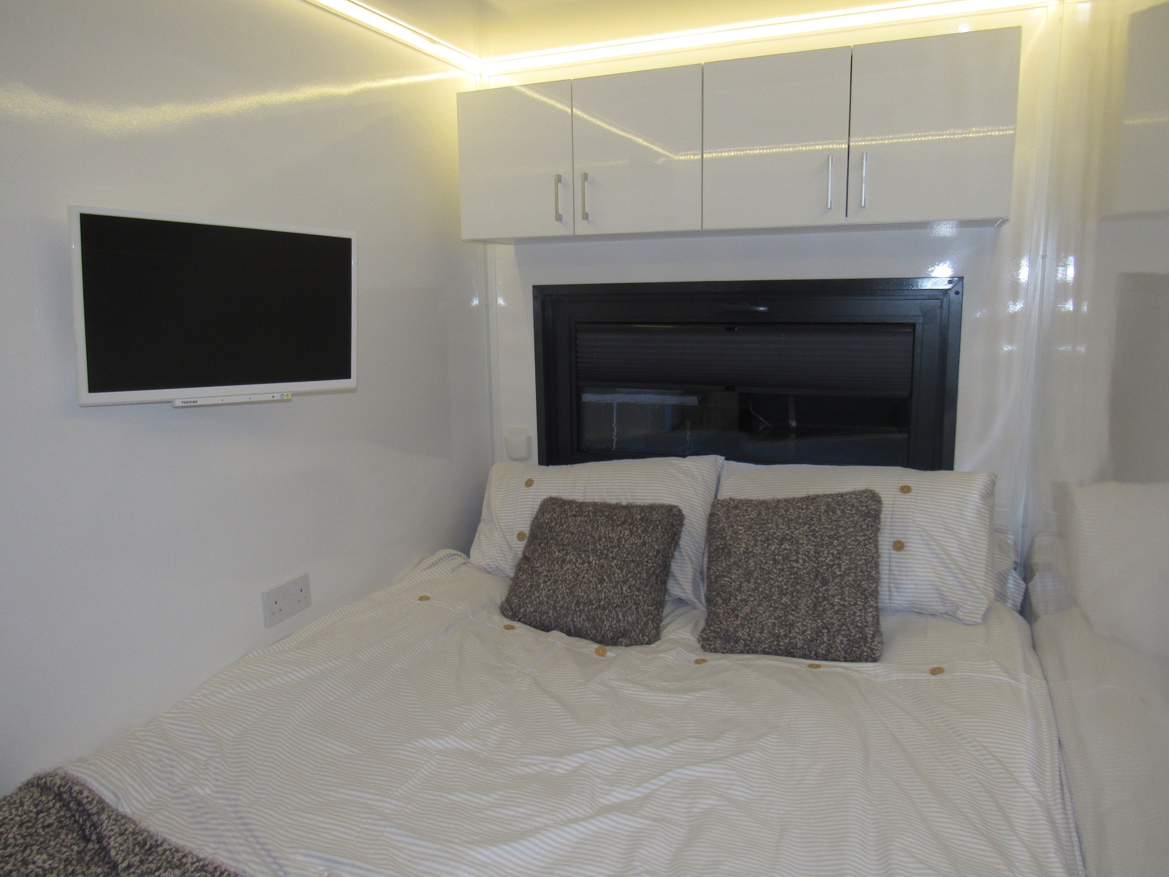 Bedroom with ambient LED lighting and king bed
