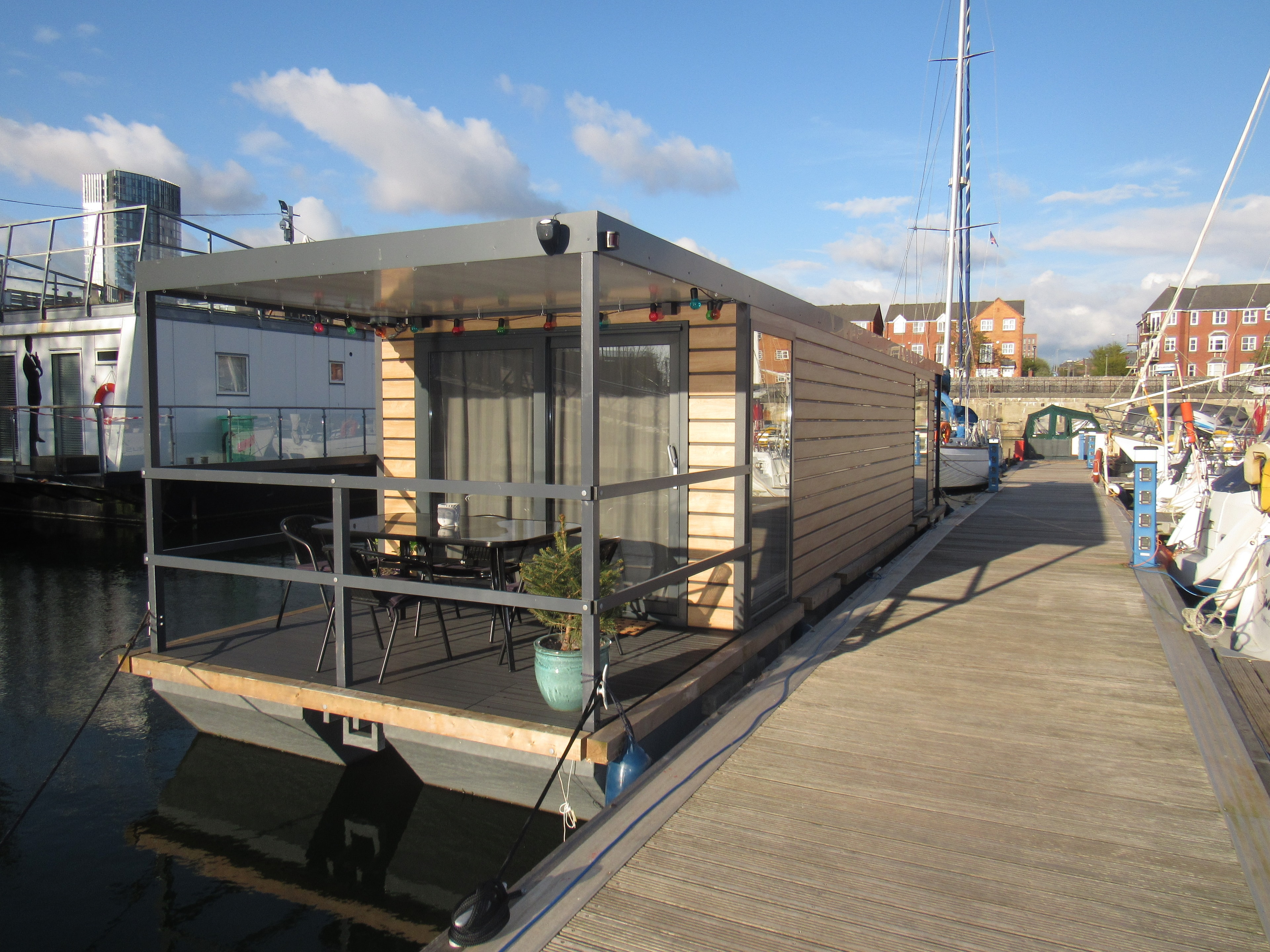 Mersey Houseboat moored at Liverpool Marina on a bright sunny day