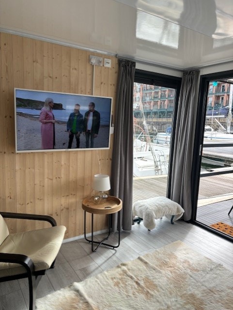 Wood-panelled living room with TV and marina views